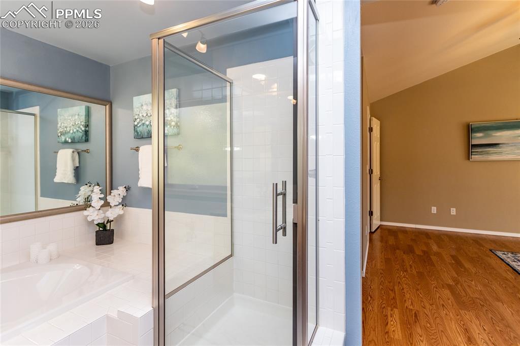 Image 31 of 50: The free-standing shower has new taller  glass doors