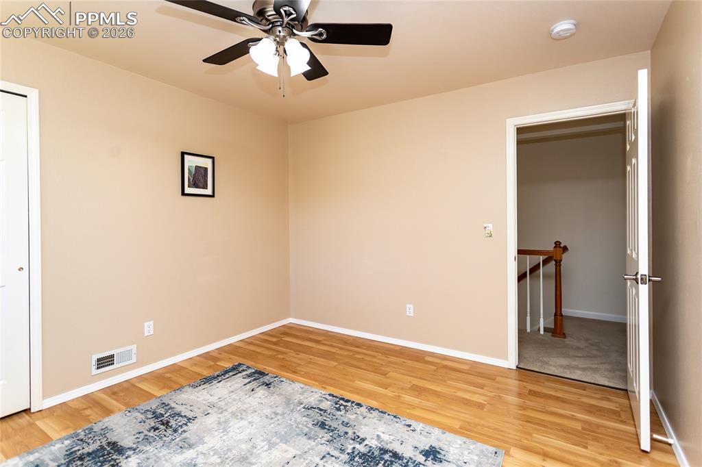 Image 33 of 50: 2nd bedroom.  Notice the laminate flooring.