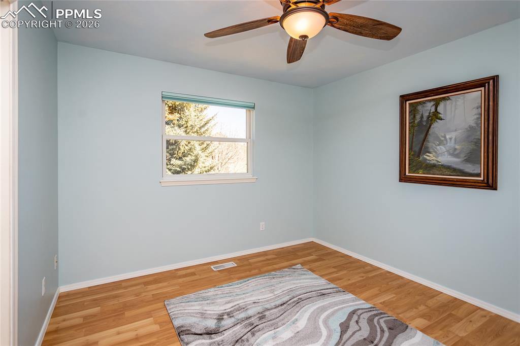 Image 34 of 50: The 3rd bedroom upstairs faces west with views of the bluffs.
