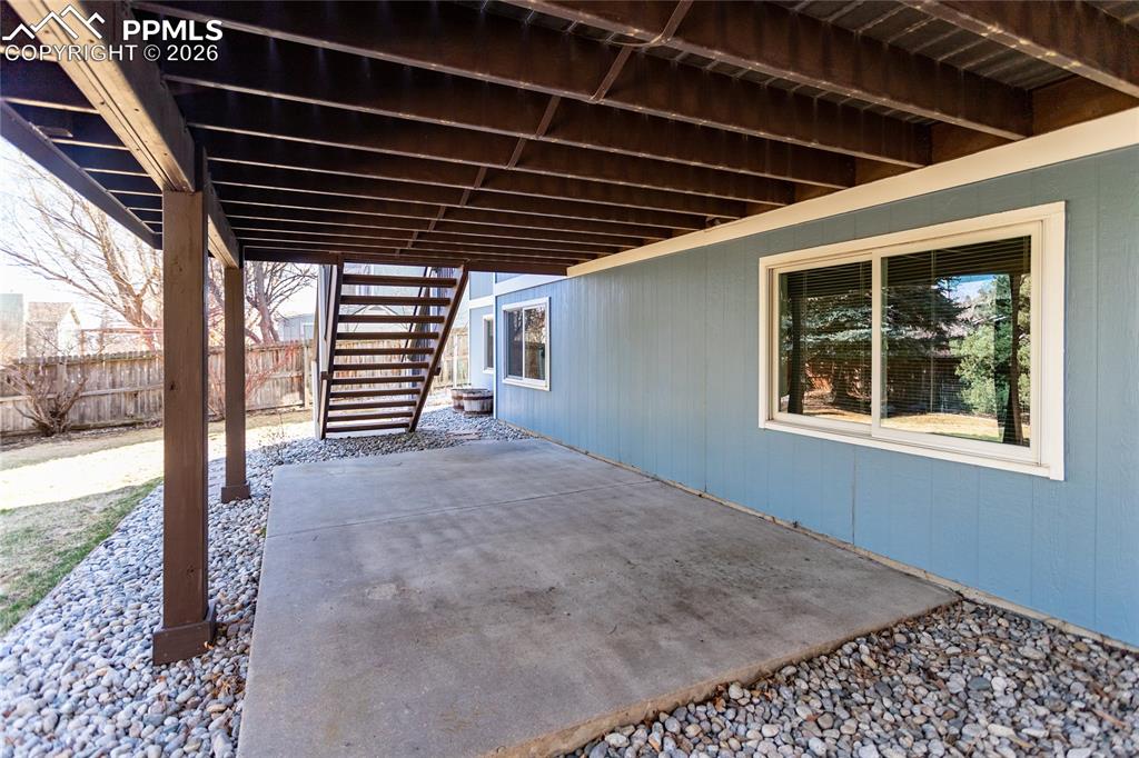 Image 49 of 50: Under the large deck.  Notice the high garden level windows to the basement