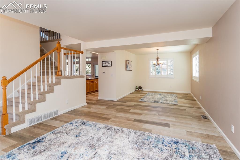 Image 7 of 50: Notice how the living room flows into the dining room.