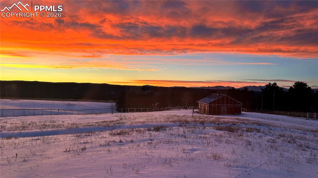 Image 16 of 46: Winter Snowy yard featuring an outbuilding
