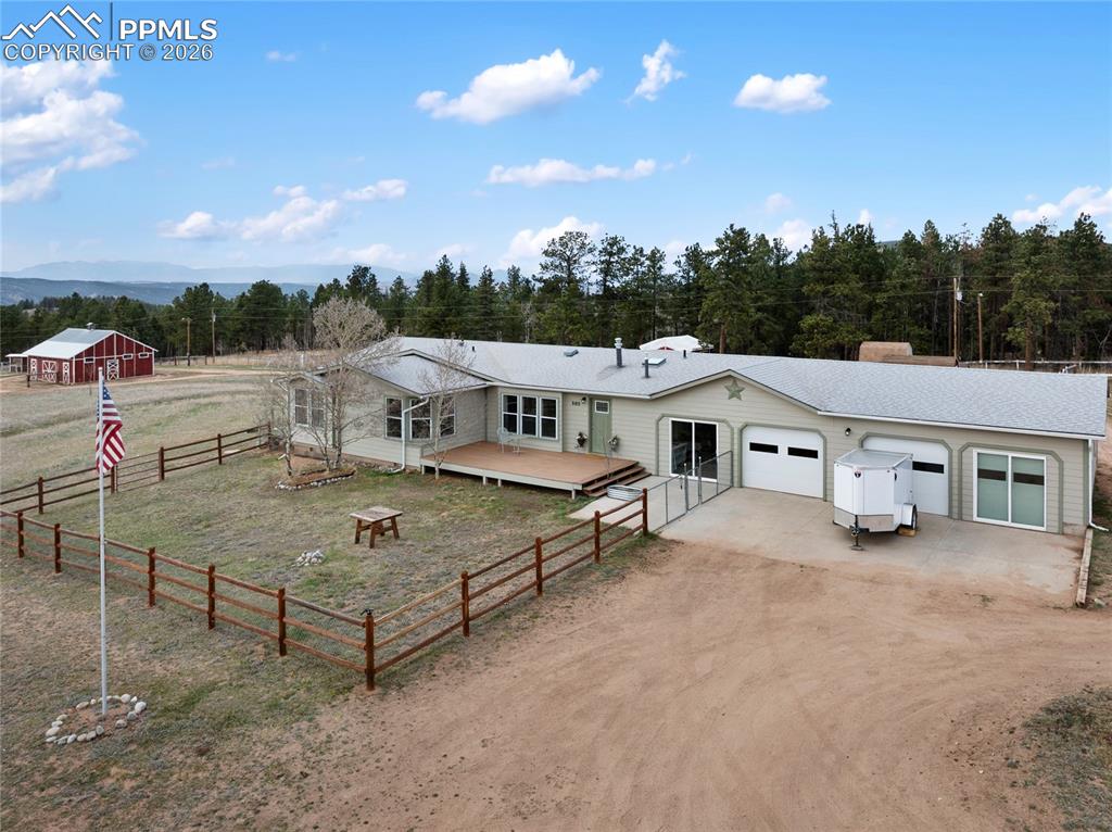 Image 2 of 46: Ranch-style home featuring driveway, an attached garage, and an outbuilding