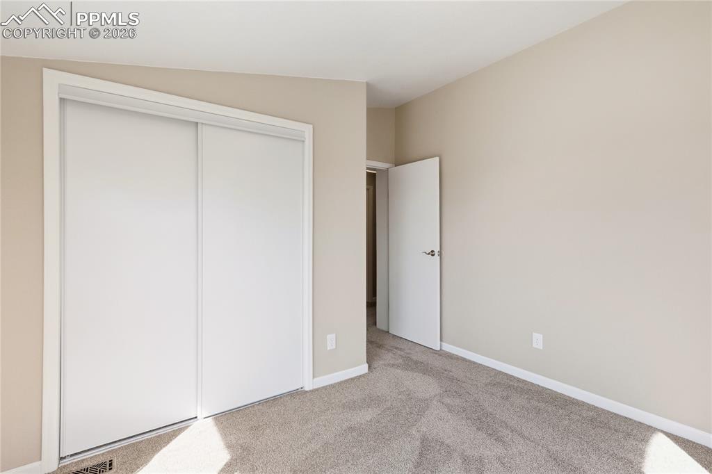 Image 36 of 46: 2nd Bdrm featuring light colored carpet and a closet