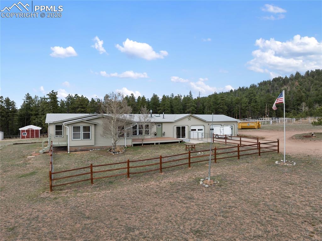 Image 4 of 46: View of front of house with a garage, a fenced front yard, and driveway