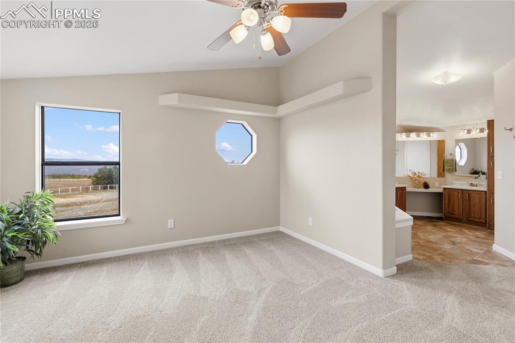 Image 40 of 46: Empty room featuring lofted ceiling, light colored carpet, healthy amount o