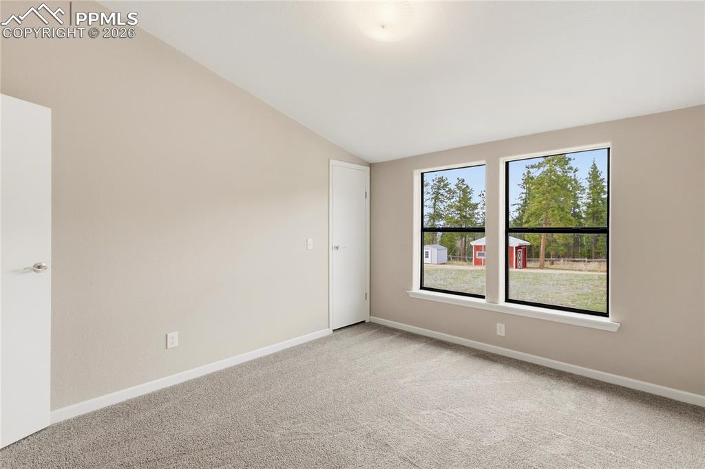 Image 44 of 46: 3rd  Bdrm featuring light colored carpet and lofted ceiling