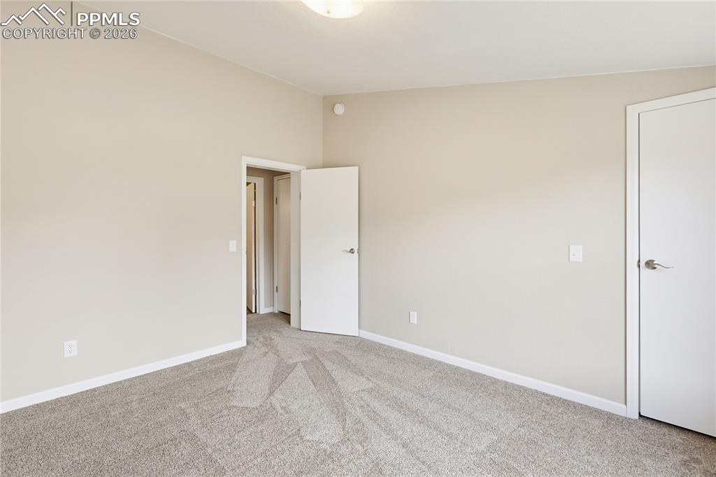 Image 45 of 46: 3rd Bdrm light colored carpet and baseboards