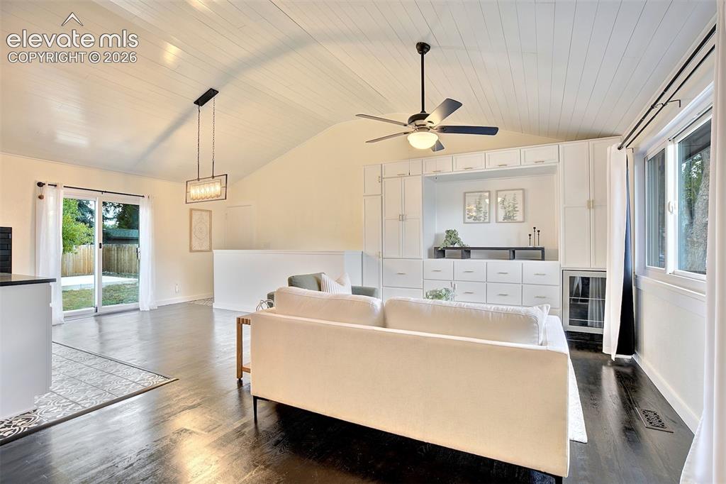 Image 2 of 43: Vaulted tongue-and-groove ceiling, dark wood-finish flooring, extensive bui