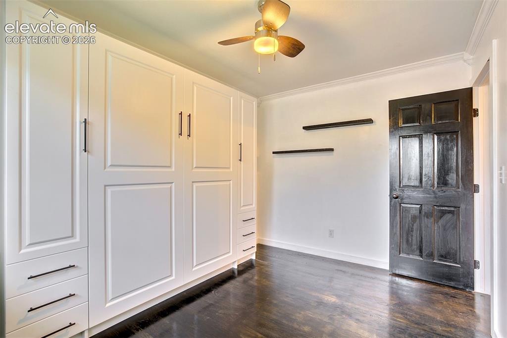 Image 26 of 43: Built-in white cabinetry with recessed-panel doors and matte black hardware