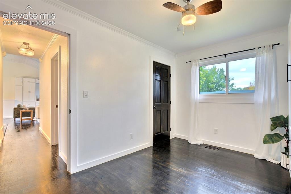 Image 27 of 43: Dark wood-finish flooring, six-panel interior door with black finish, ceili