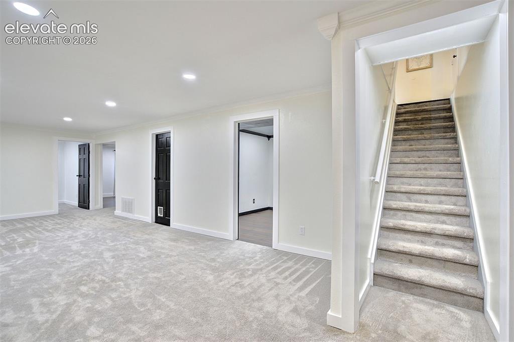 Image 29 of 43: Interior space featuring neutral wall-to-wall carpeting, recessed ceiling l