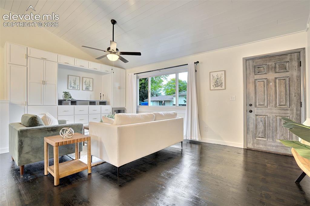 Image 3 of 43: Vaulted ceilings with white plank detailing, dark wood-finish flooring, bui