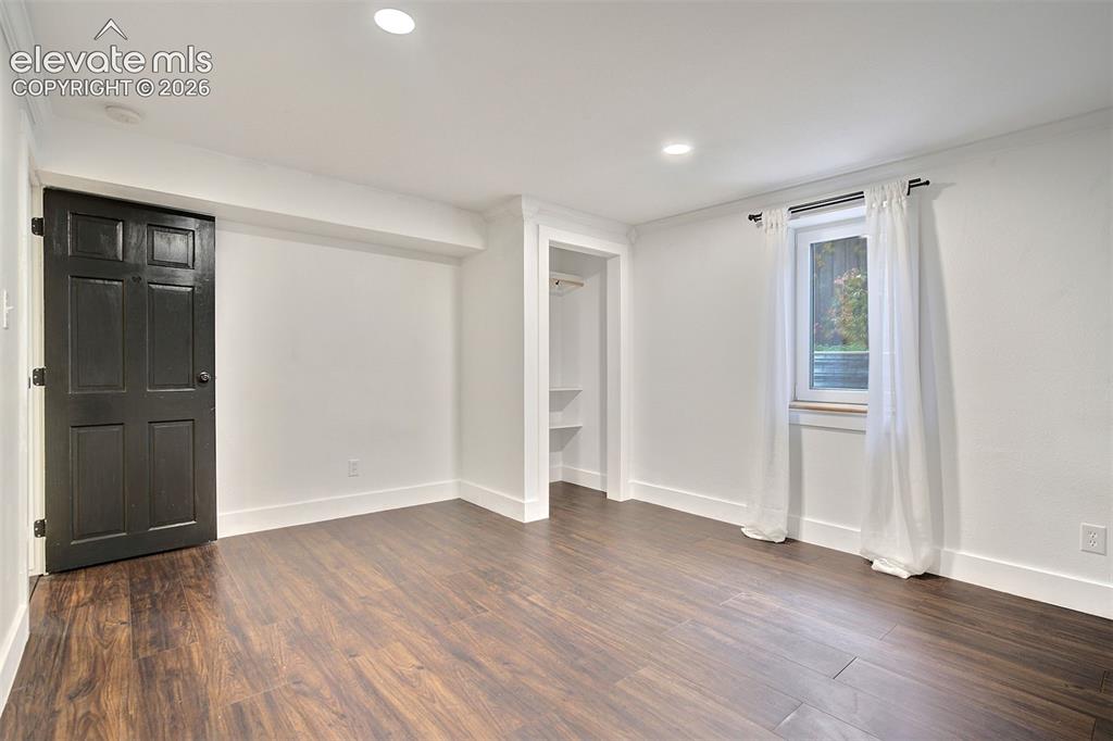 Image 38 of 43: Room featuring wood-finish flooring, recessed lighting, a high-contrast dar