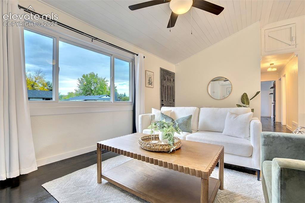 Image 4 of 43: Vaulted ceiling with shiplap detailing, large picture window, dark wood-fin