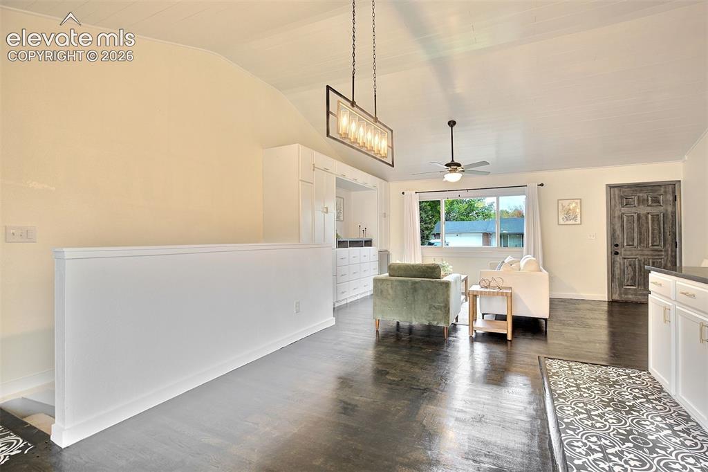 Image 7 of 43: Vaulted ceilings with tongue-and-groove paneling, dark wood-finish flooring