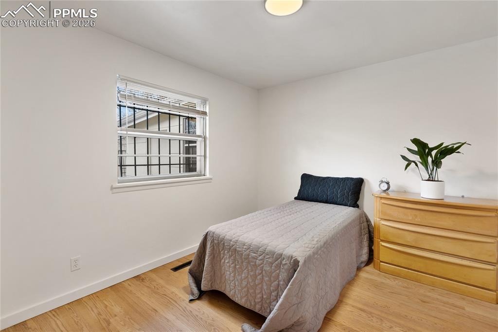 Image 17 of 37: One of 3 bedrooms on the main level.  Refinished hardwood flooring, new doo