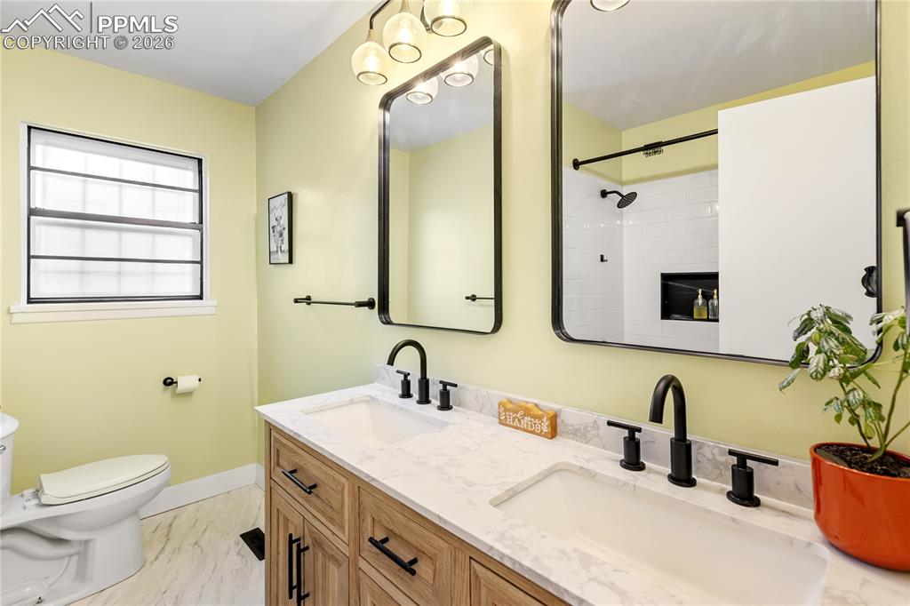 Image 21 of 37: Main level hall bathroom - beautifully remodeled.