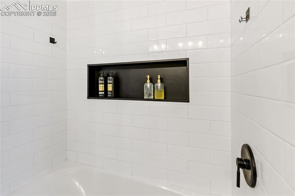 Image 22 of 37: Main level hall bathroom - beautifully remodeled.