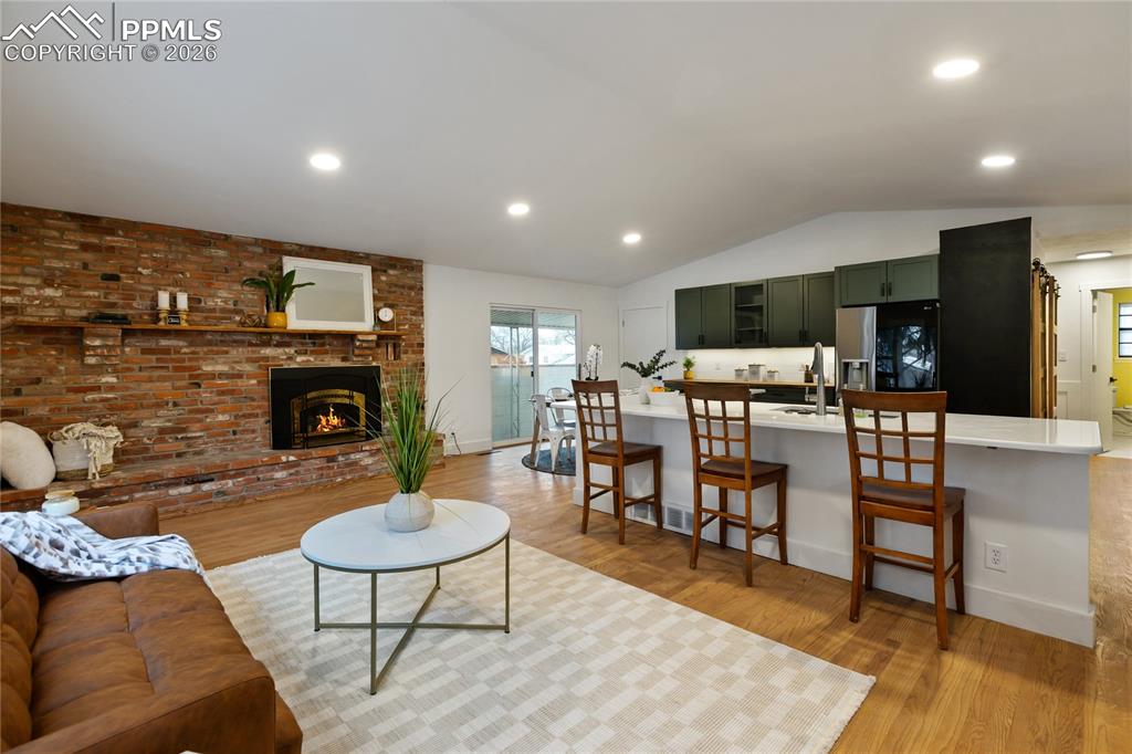 Image 4 of 37: Remodeled kitchen includes all new appliances, breakfast bar.  Gas fireplac