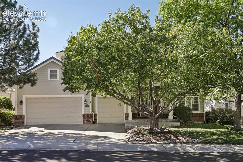 Image 1 of 49: Siding exterior with brick accents, dual garage doors, and front yard lands