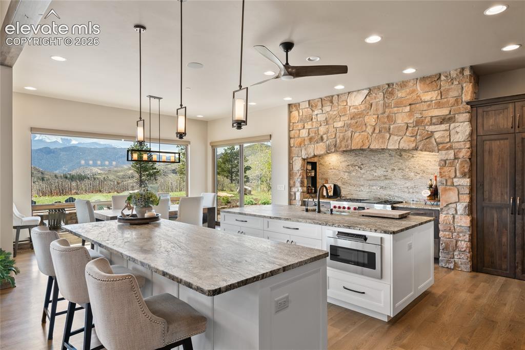 Image 12 of 50: Spacious entertaining kitchen with dual leathered granite islands, custom p