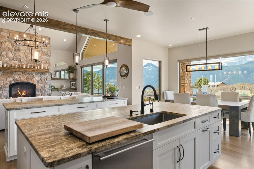 Image 17 of 50: Oversized leathered granite prep island with deep undermount sink, opening