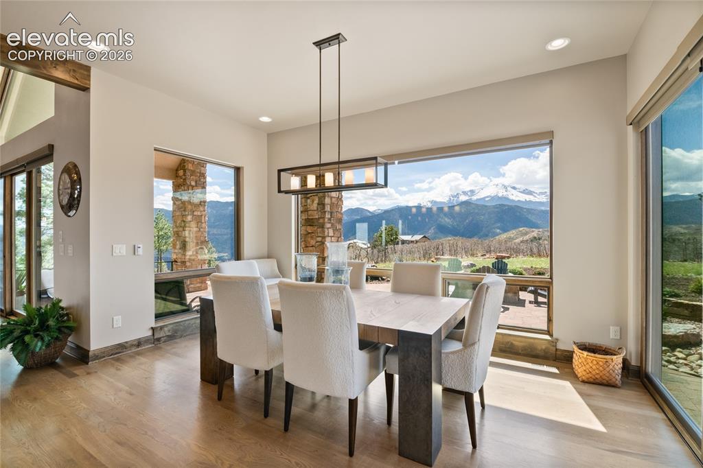 Image 18 of 50: Bright dining space anchored by a 145-inch picture window showcasing Pikes