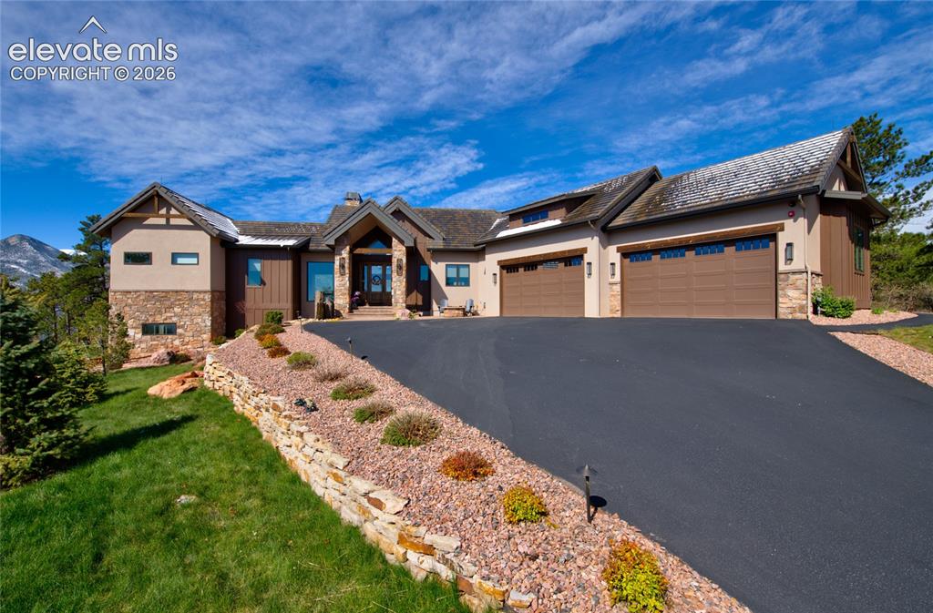 Image 2 of 50: Built for Colorado living. Expansive side elevation featuring a 4-car attac