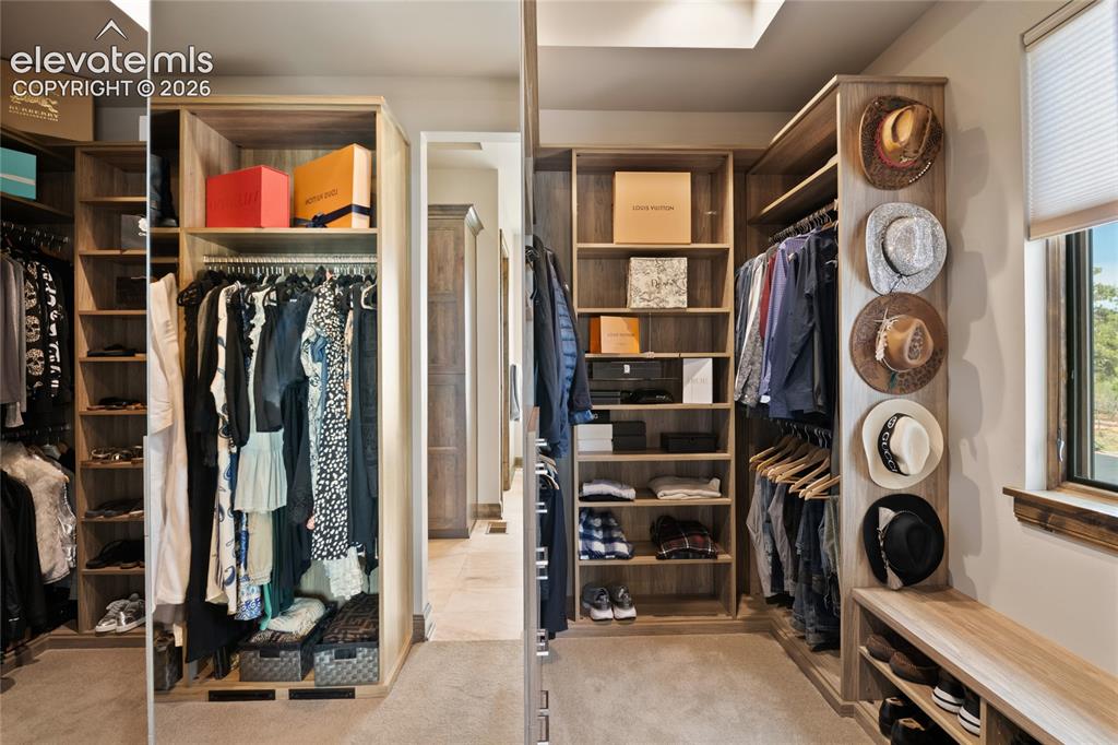 Image 27 of 50: Designed for a curated collection. Bespoke walk-in dressing room with full-