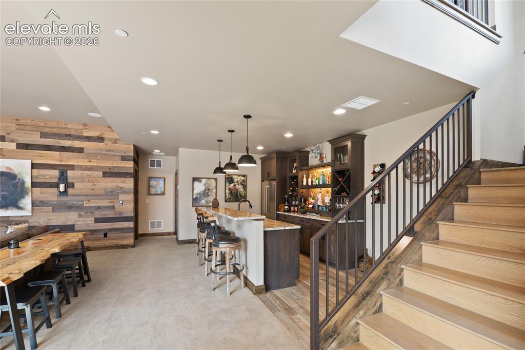 Image 33 of 50: The party officially has a destination. Lower-level entertaining space with