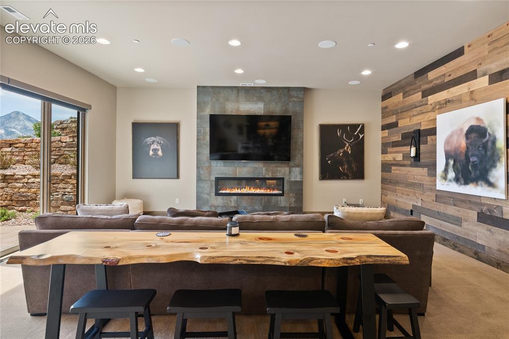 Image 34 of 50: Movie night just got an upgrade. Lower-level theater area with linear gas f