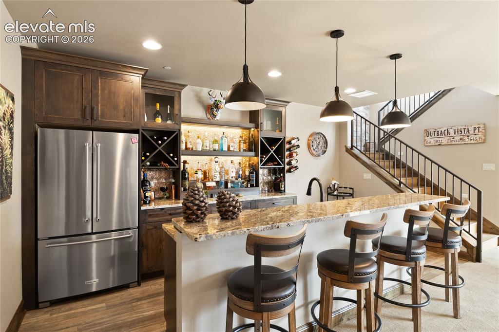 Image 37 of 50: The unofficial favorite room in the house. Full wet bar with stainless frid