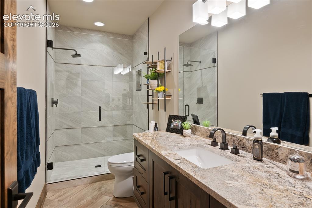 Image 39 of 50: Hall bath that could pass for an ensuite. Large walk-in shower with full ti