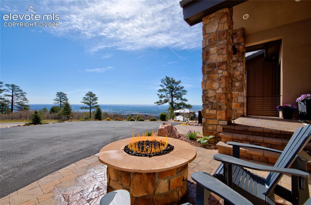 Image 4 of 50: The view starts the moment you arrive. Front entry patio featuring a custom