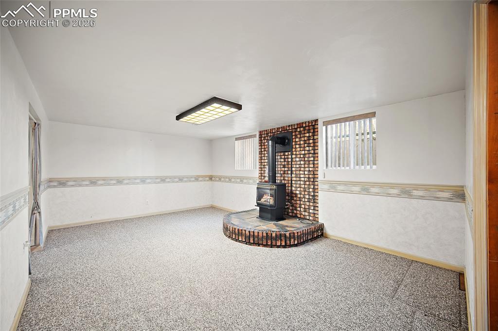 Image 23 of 48: Lower level Family room with gas fireplace.  