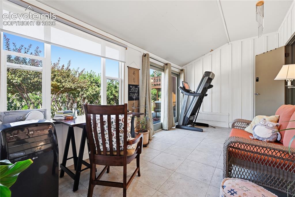 Image 14 of 44: Views out the windows of sun room with multiple uses.