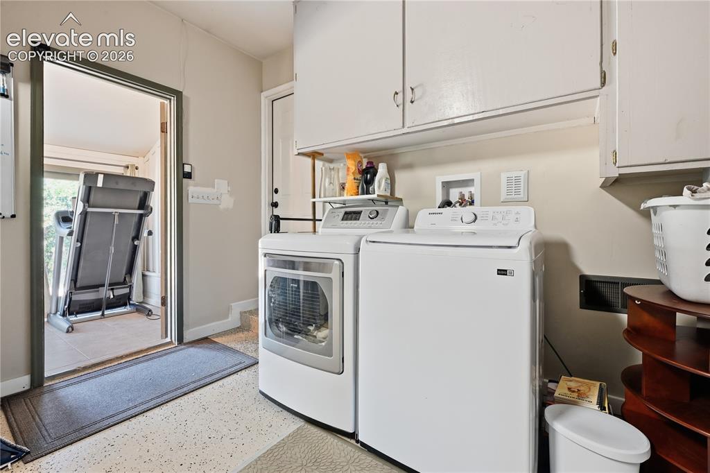 Image 15 of 44: Laundry area just off kitchen in front of sun room