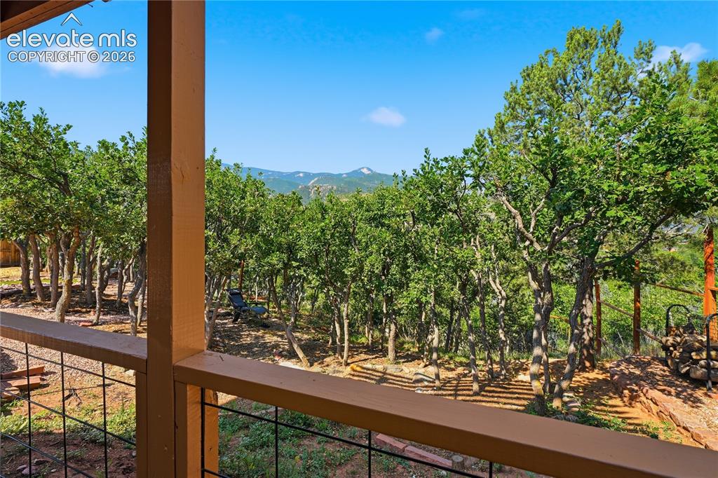 Image 23 of 44: Lower level patios views towards yard and West views of mountains.