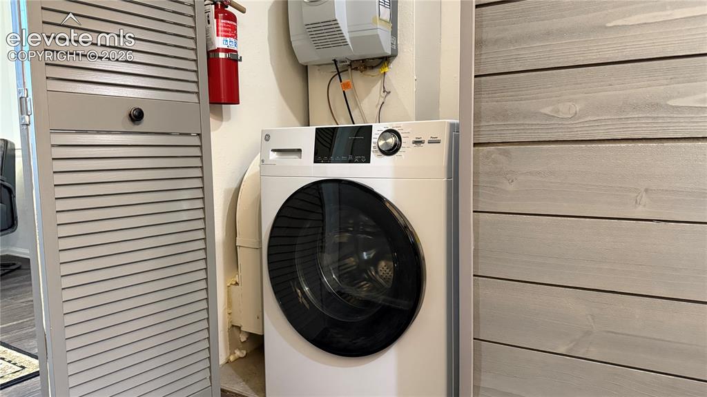Image 25 of 44: Combo Washer and Dryer unit in the lower level, great for guests or potenti