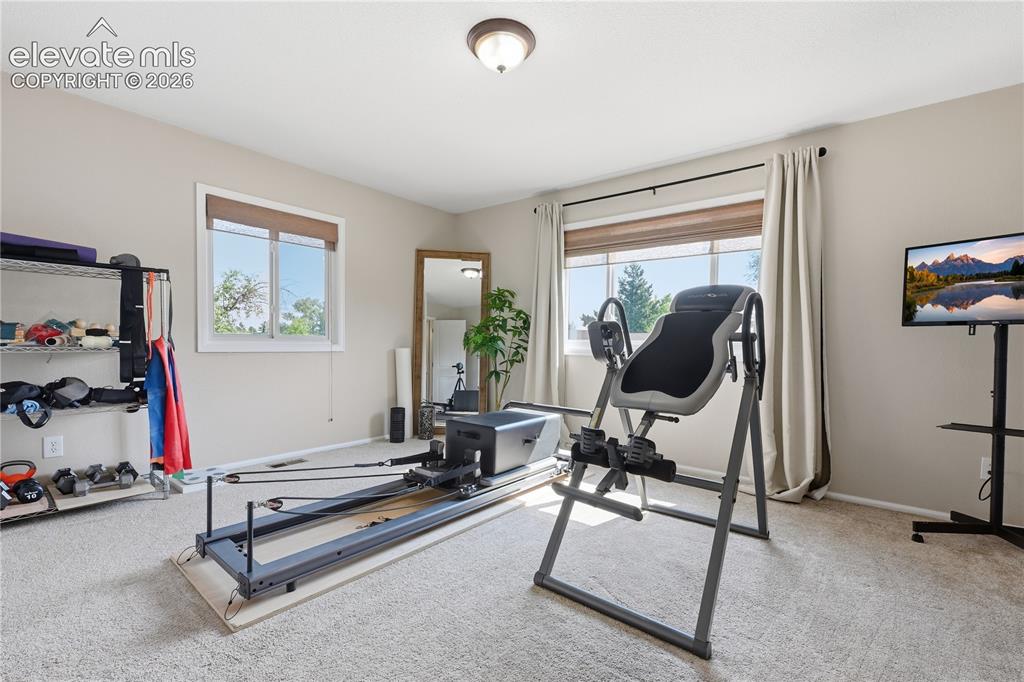 Image 34 of 44: Upper level bedroom being used as a gym right now.  Large bedroom tons of l