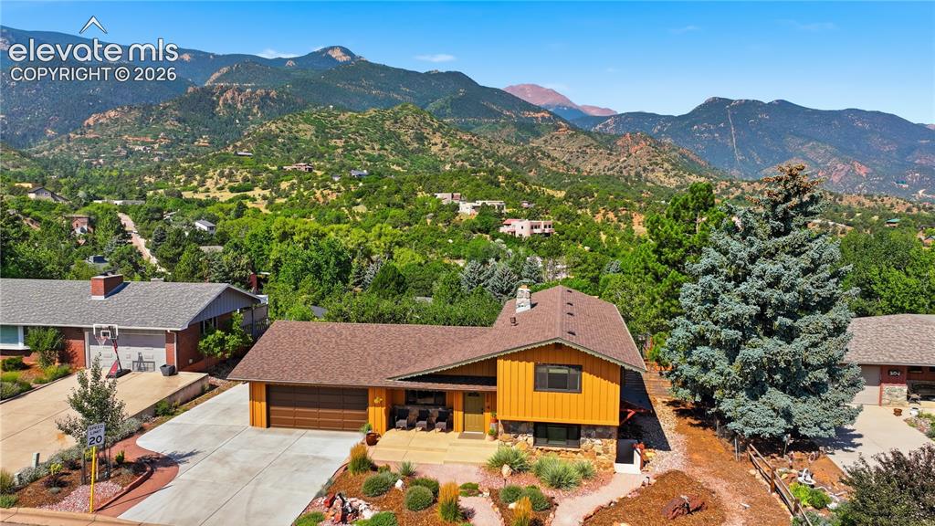 Image 37 of 44: View of home and where it sits with views of Pikes Peak and the valley arou