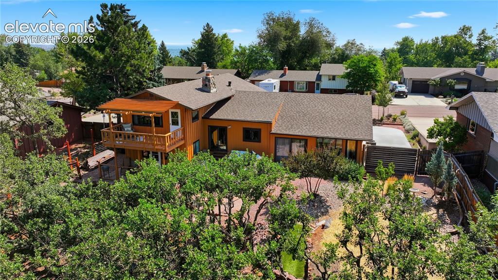 Image 43 of 44: Airel shot of the back of the home.  New roof, gutters and exterior paint.