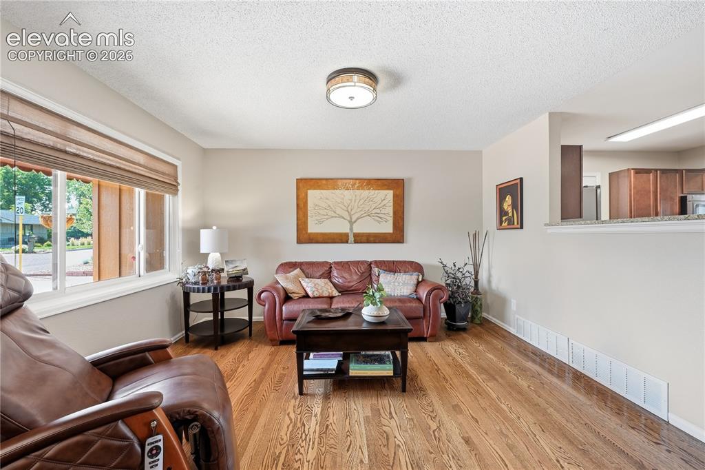 Image 6 of 44: Living room is open to kitchen great for entertaining conversations while c