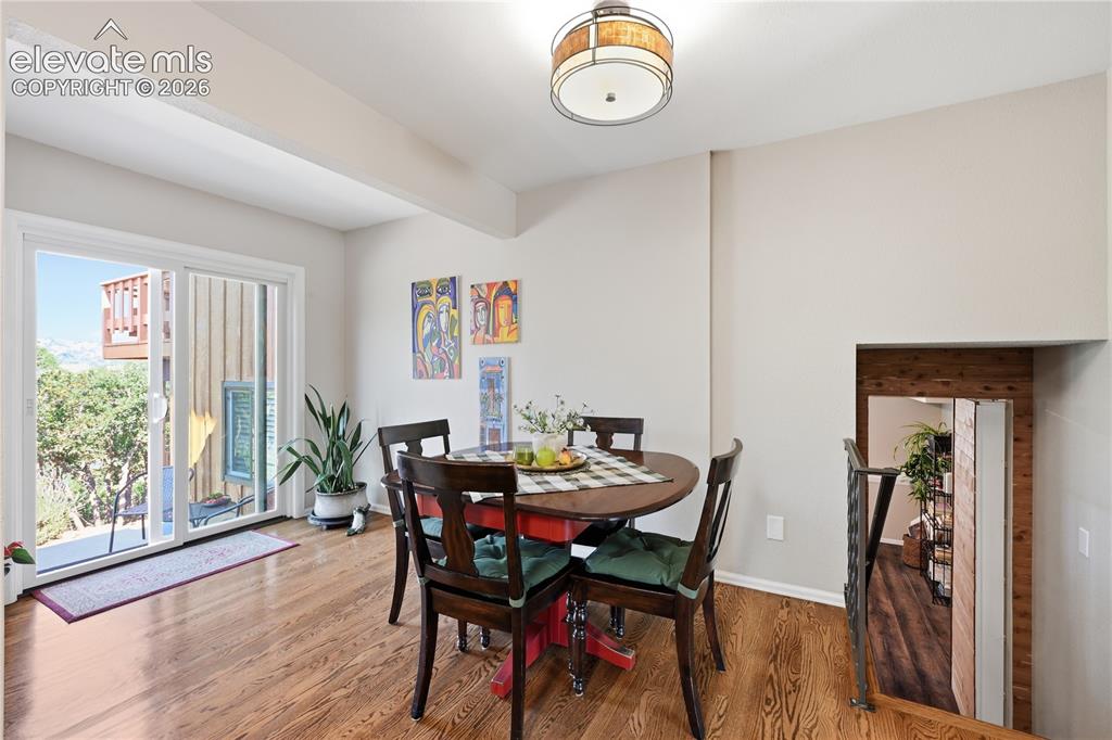Image 8 of 44: Dining area with hardwood flooring throughout the main level.