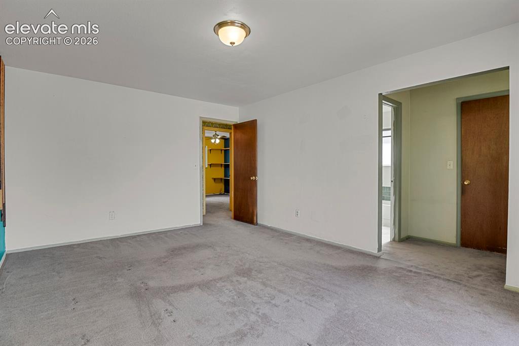 Image 13 of 35: Recessed ceiling light fixture, white painted walls, wood paneling, wood do