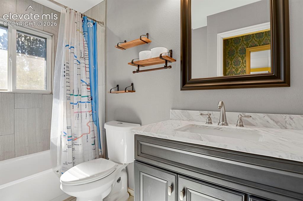 Image 17 of 35: Vanity with a light-toned countertop and an undermount sink