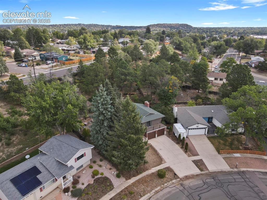 Image 30 of 35: Residential neighborhood setting with mature trees and paved streets