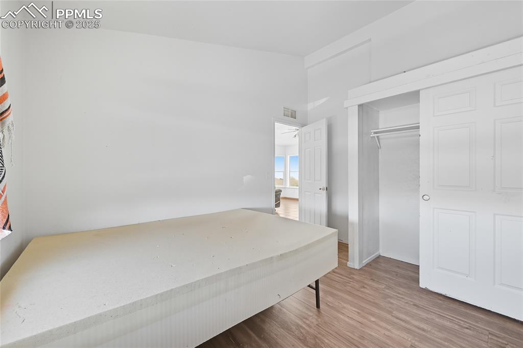 Image 20 of 28: Bedroom featuring light wood finished floors and a closet