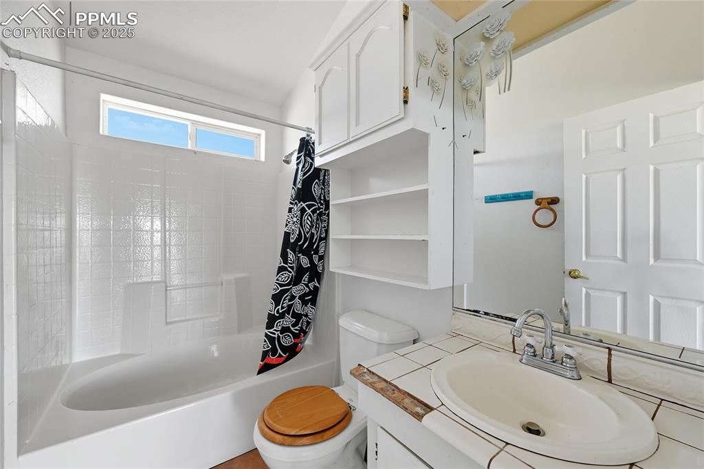 Image 21 of 28: Bathroom with vanity and shower / bath combo